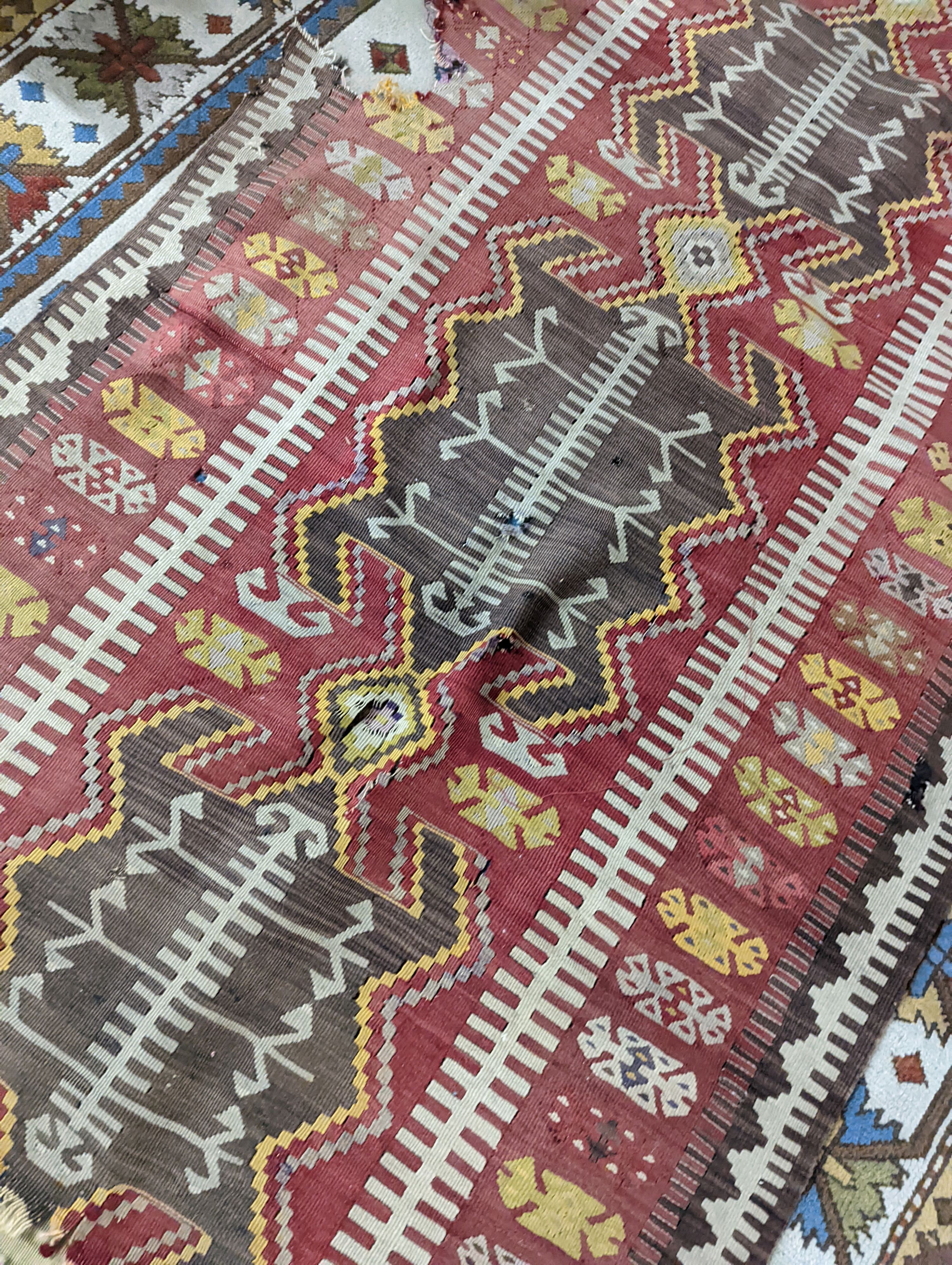 A Kilim polychrome flatweave runner, 380 x 118cm (holed)